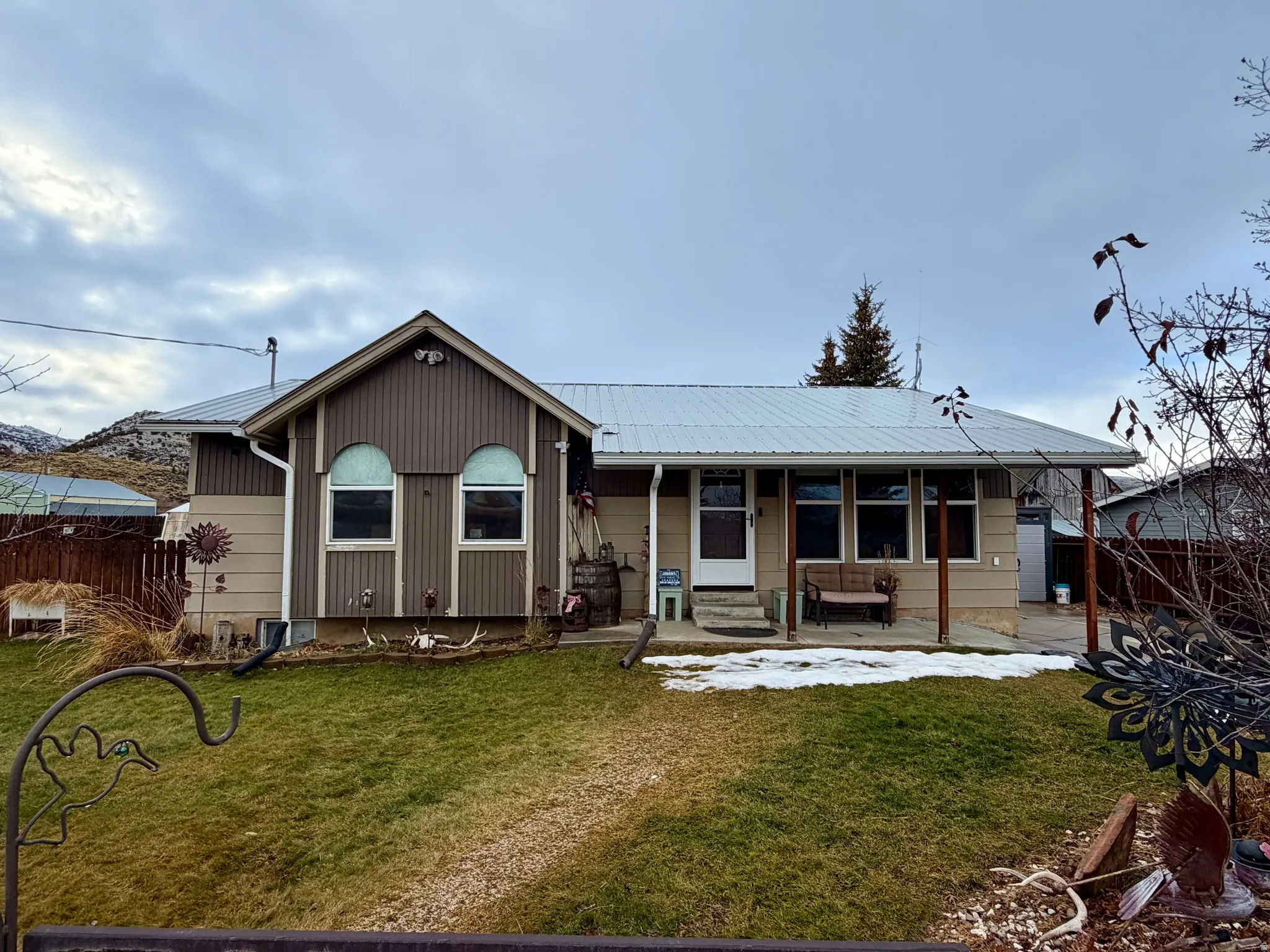 View of front of home featuring a metal roof and covered porch