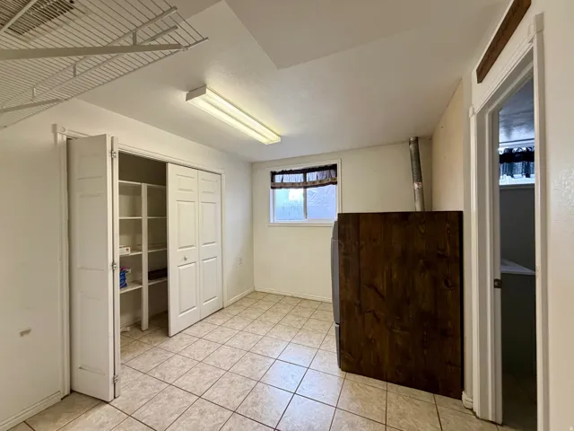 Unfurnished bedroom featuring a closet and light tile patterned flooring