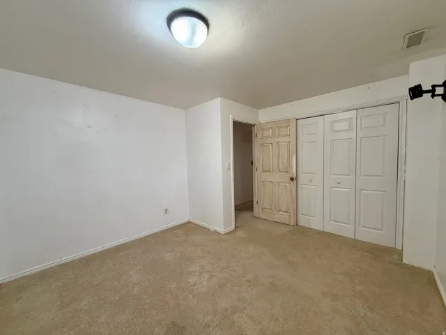 Unfurnished bedroom with carpet floors and a closet