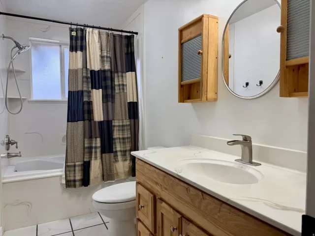 Full bathroom featuring vanity and shower / tub combo
