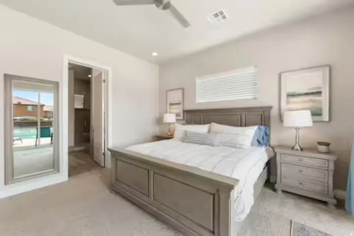 Bedroom with light carpet, ensuite bath, a ceiling fan, and recessed lighting