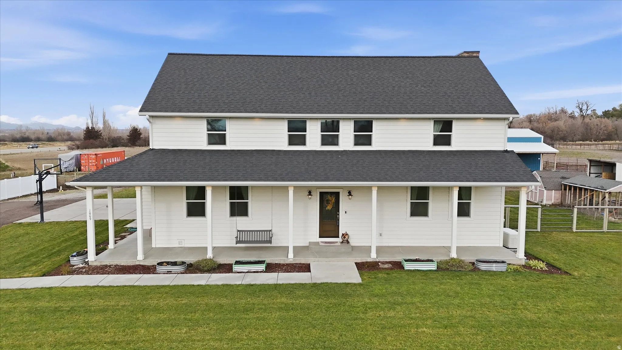 Farmhouse with a porch and roof with shingles