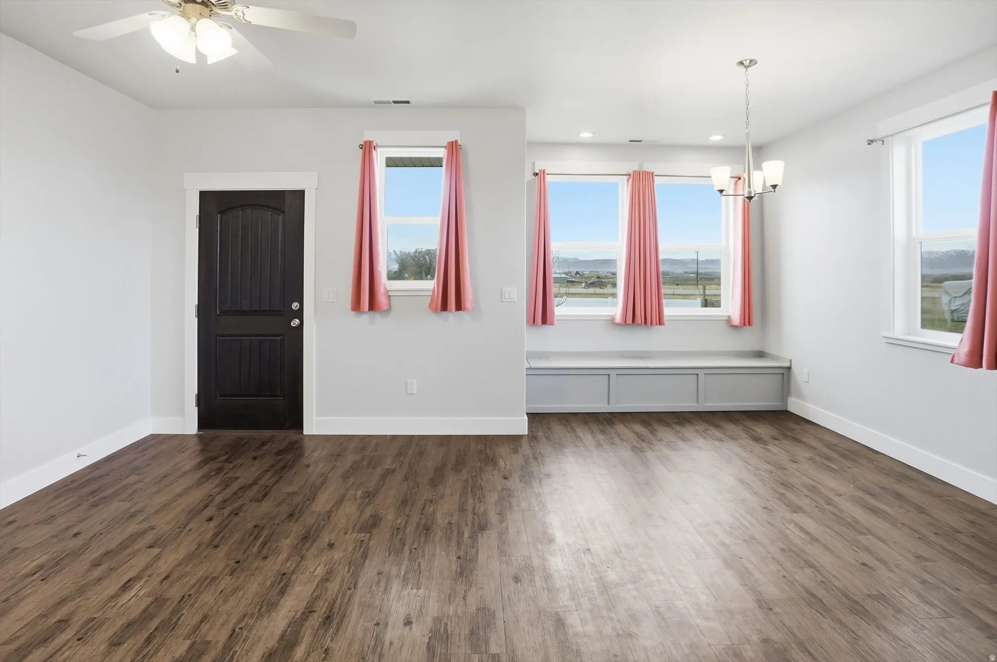 ADU Entryway featuring dark wood-type flooring, a chandelier, and ceiling fan