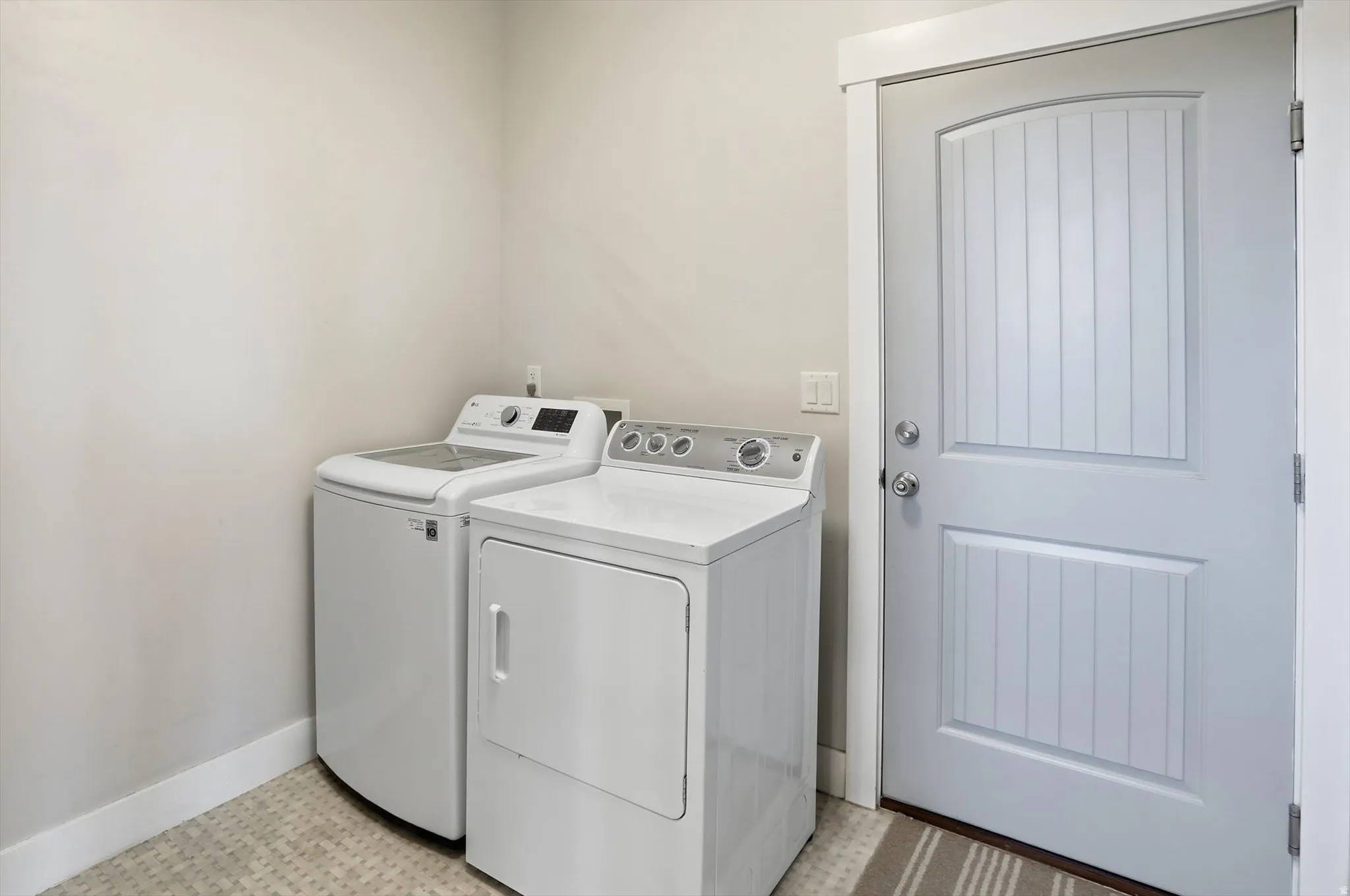 ADU Laundry area featuring light flooring and washer and clothes dryer