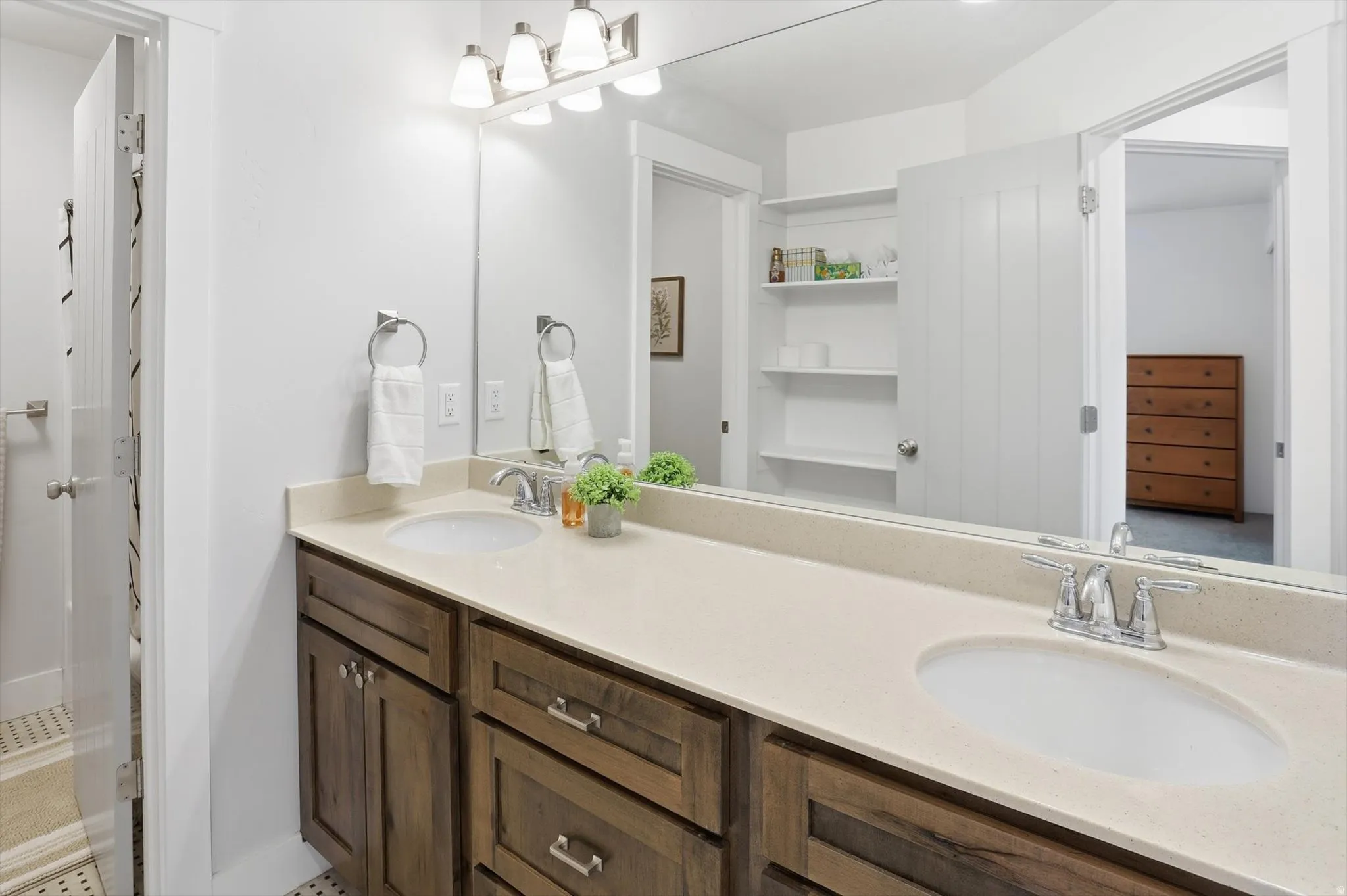 Full bathroom with double vanity and a shower