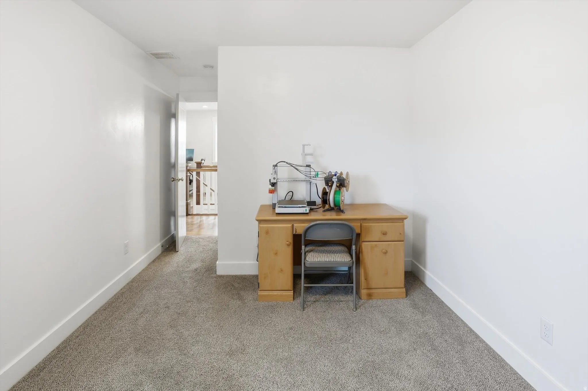 Office space or guest bedroom with carpet flooring and baseboards