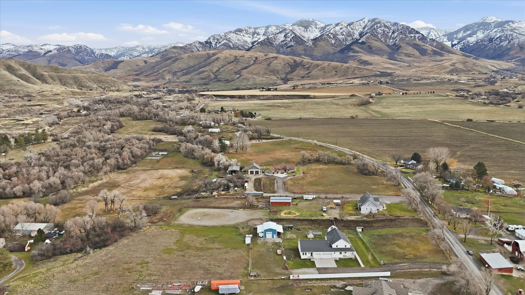 Aerial overview of property's location featuring a mountainous background and rural landscape