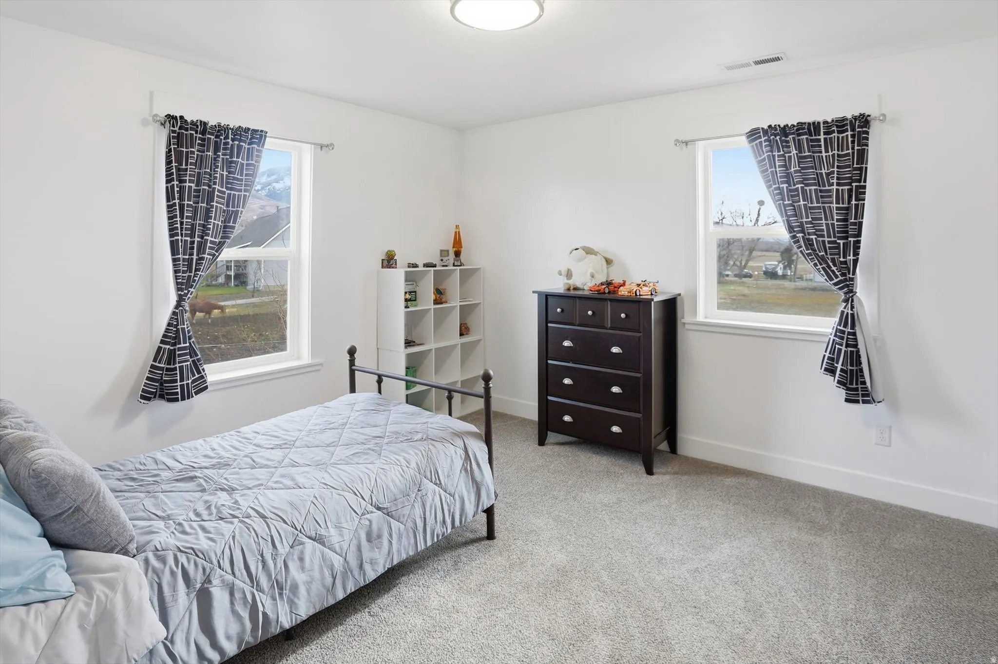 Bedroom featuring carpet and baseboards