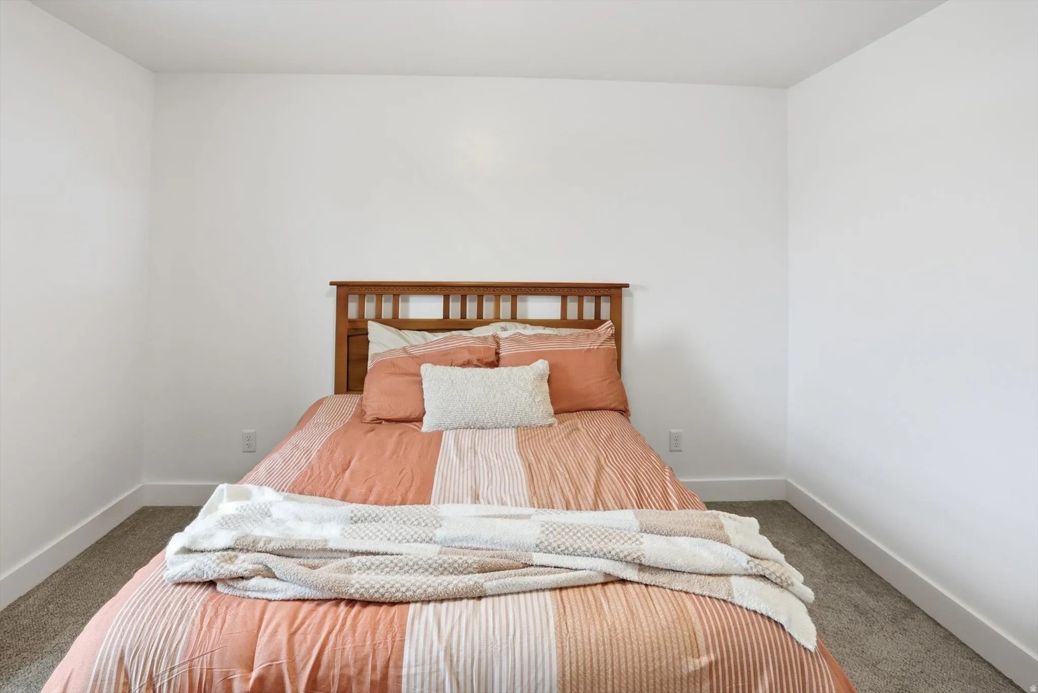 Carpeted bedroom featuring baseboards