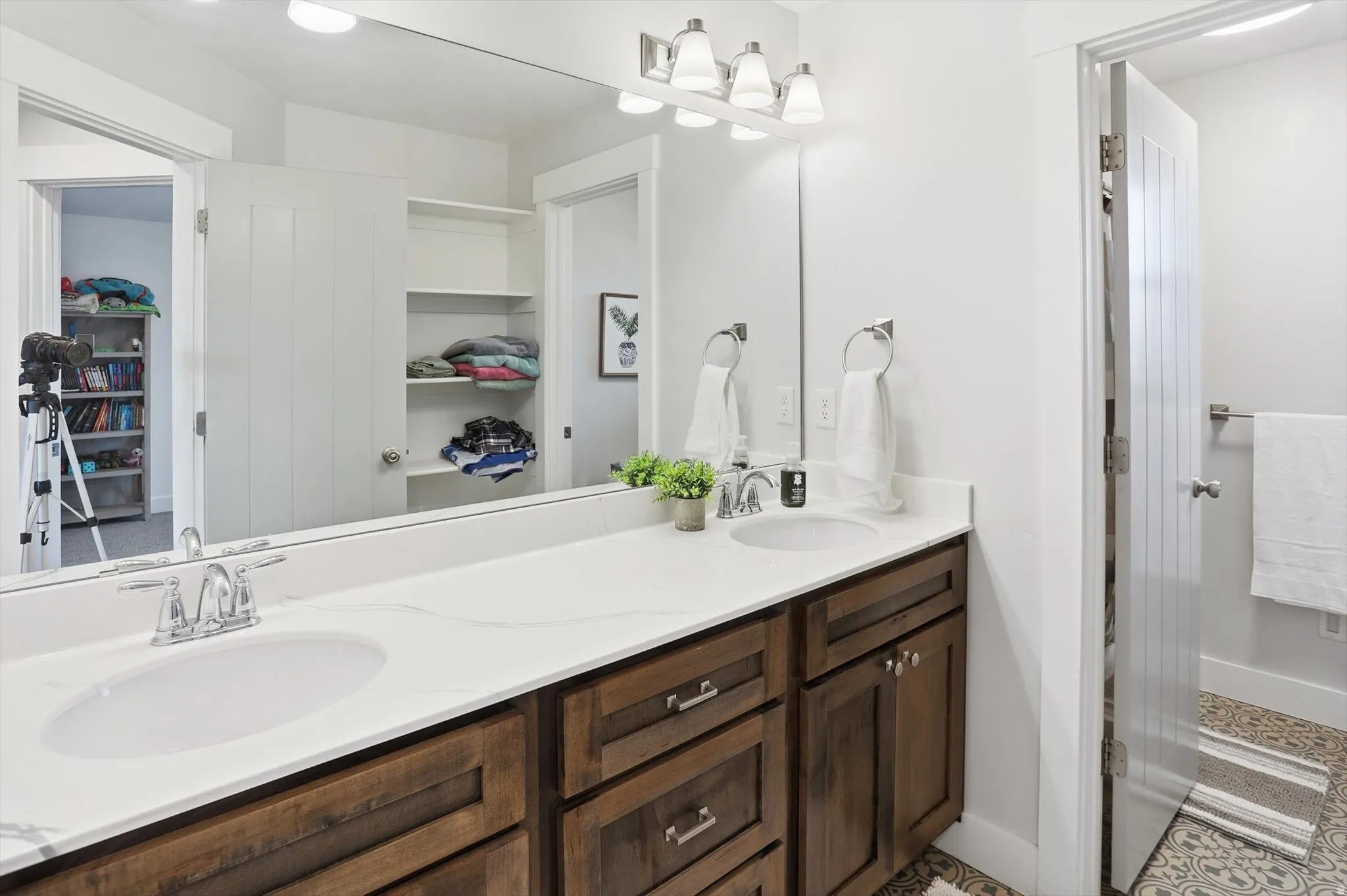 Bathroom featuring a walk in closet and double vanity