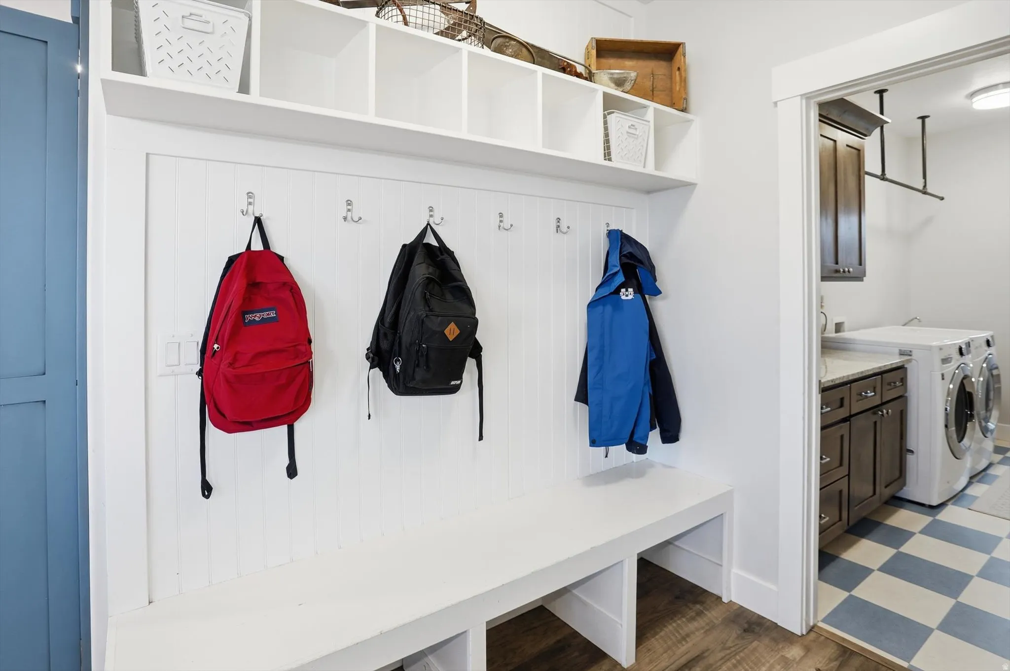 Mudroom featuring independent washer and dryer and dark floors