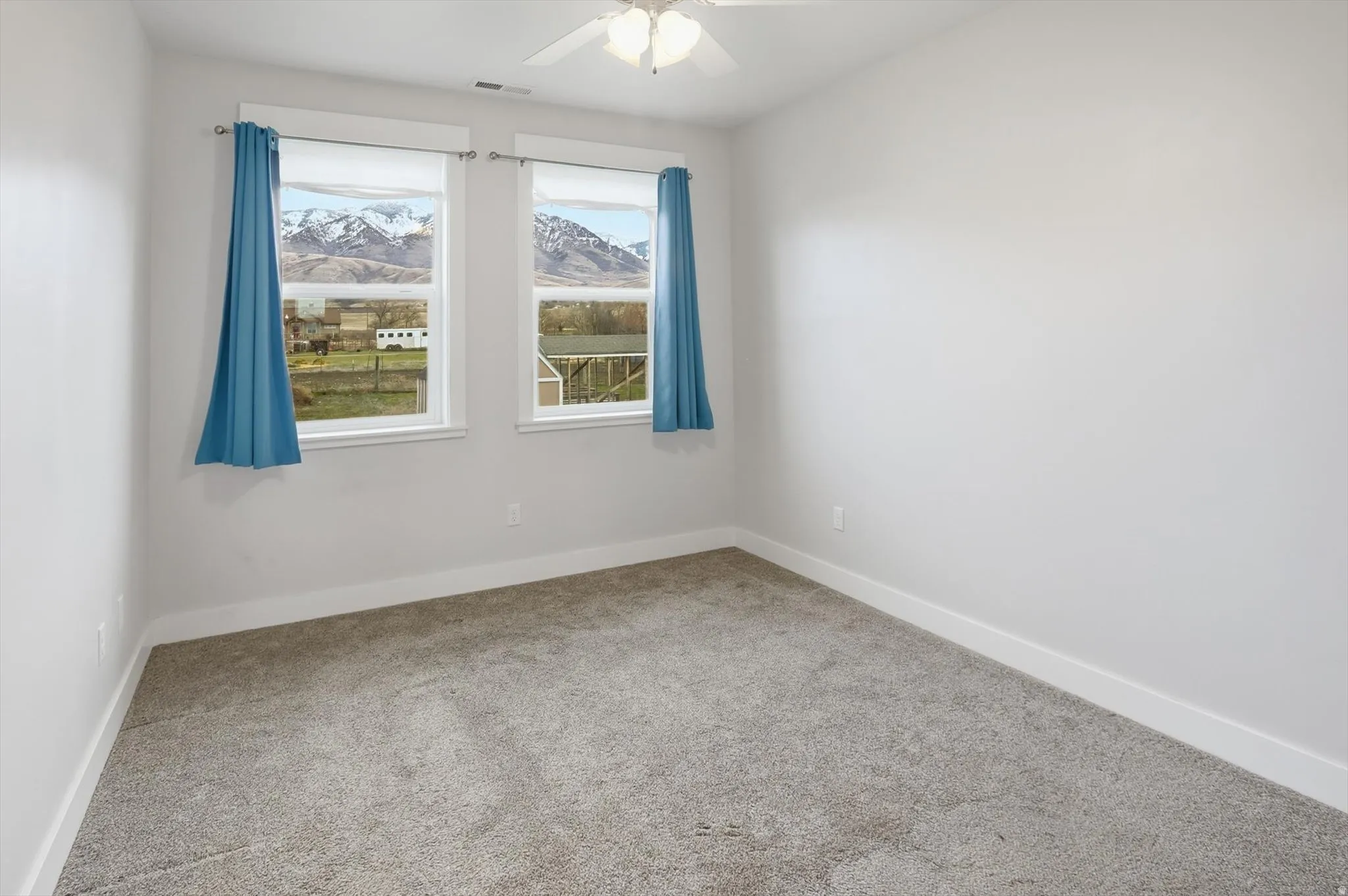 ADU Bedroom featuring a ceiling fan and a mountain view