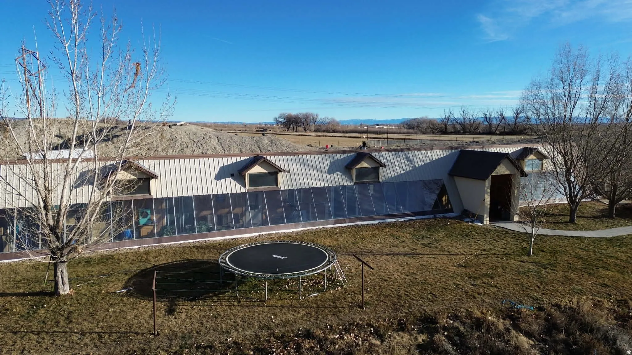 Exterior space featuring a yard and a trampoline