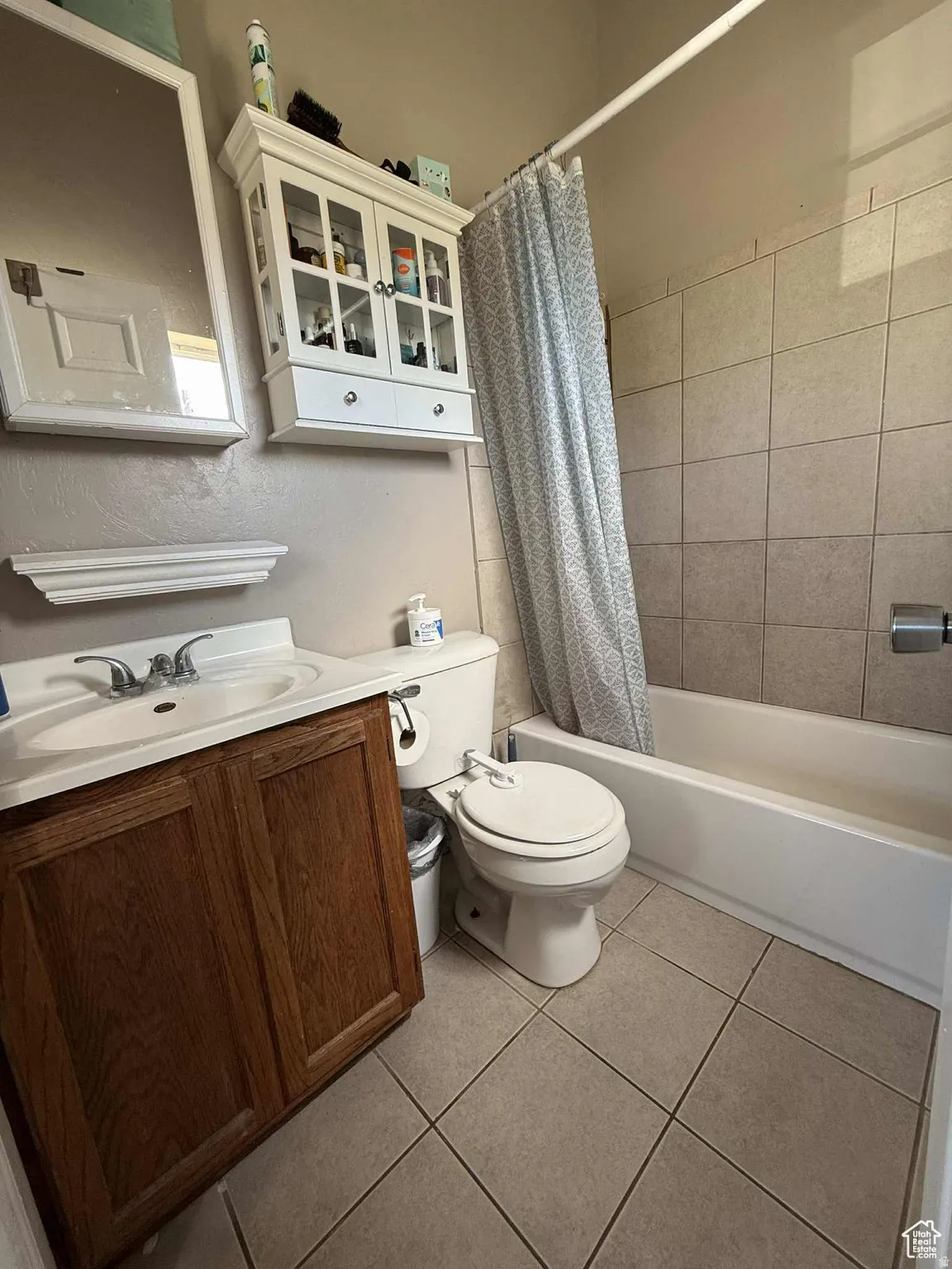 Full bathroom featuring vanity, shower / tub combo, and light tile patterned floors