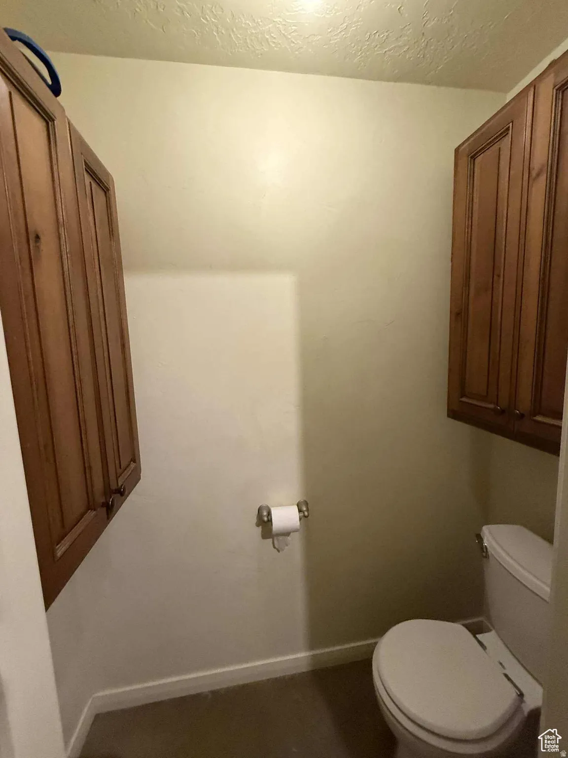 Bathroom featuring toilet and a textured ceiling