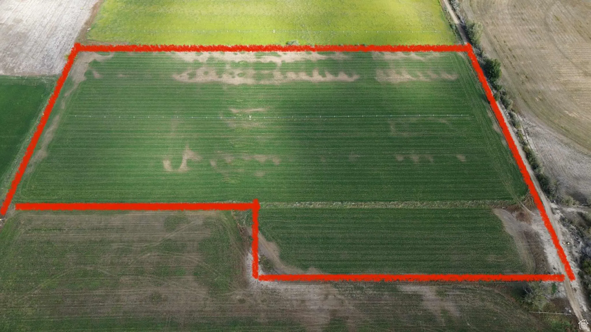 Overview of rural landscape with farmland and property parcel outlined