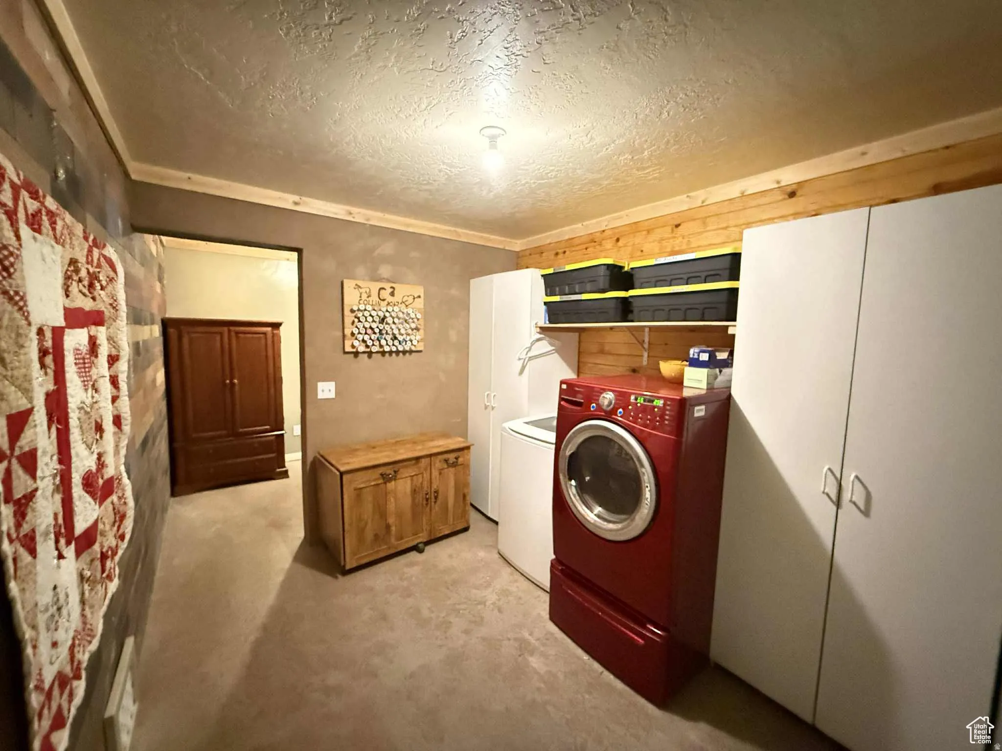 Laundry area featuring a textured ceiling and washing machine and dryer