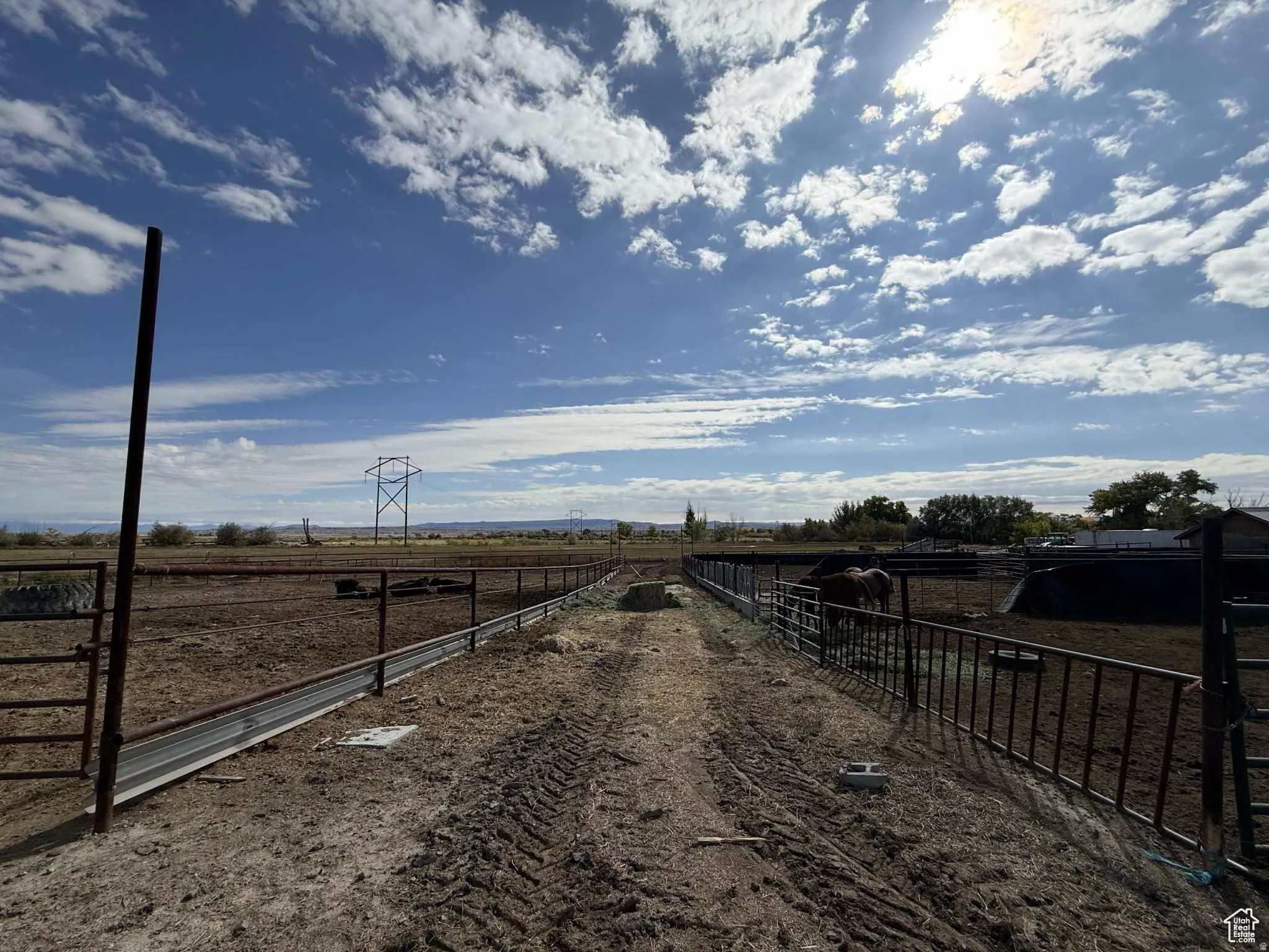 View of dirt / gravel road featuring a view of rural / pastoral area