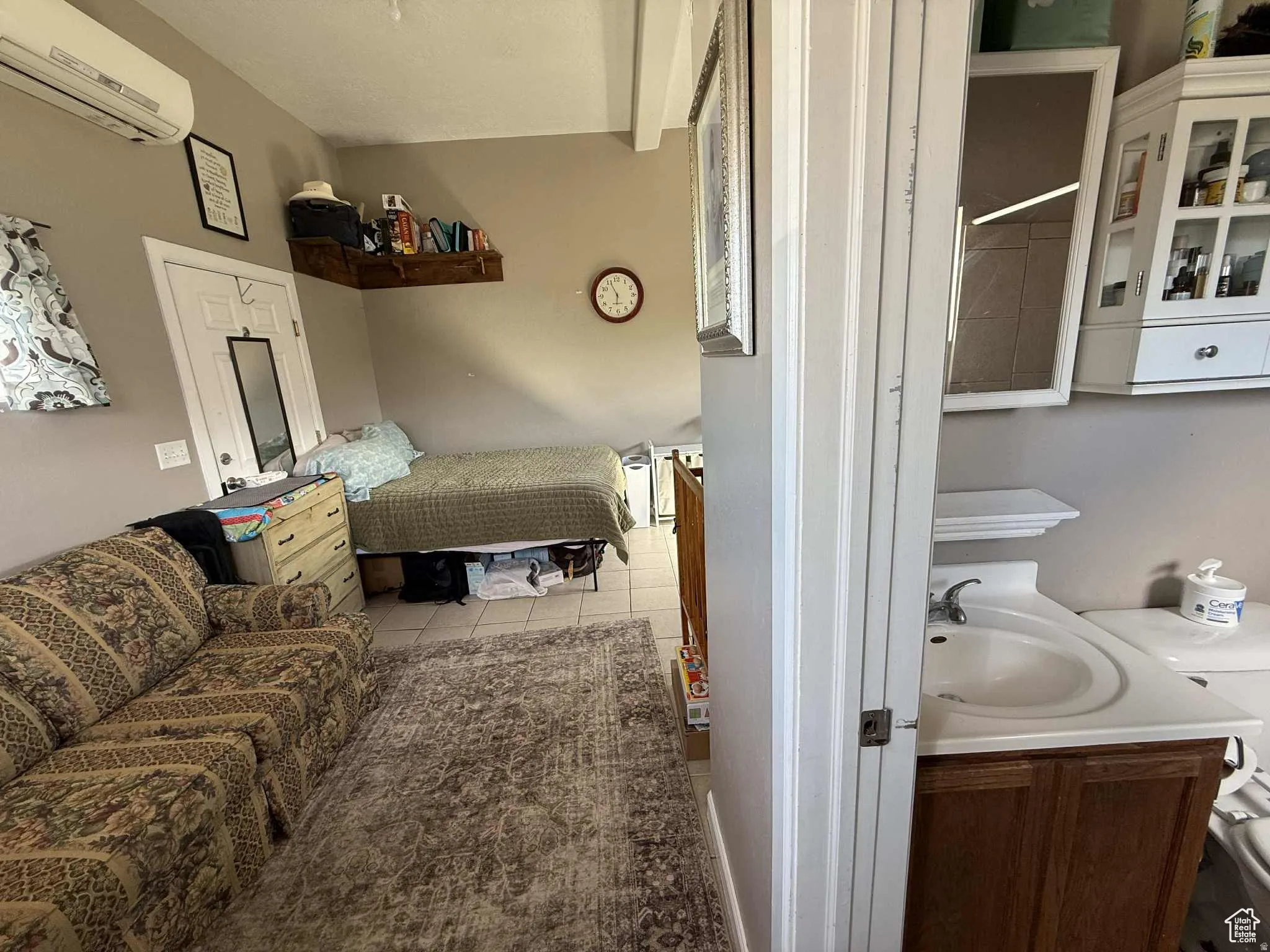 Bedroom featuring a wall mounted AC and light tile patterned floors