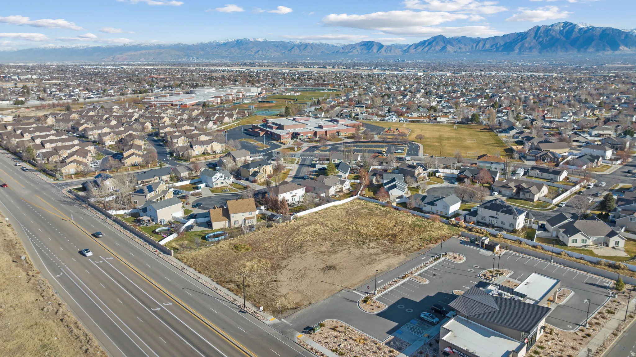 Aerial overview of property's location with nearby suburban area and a mountain backdrop