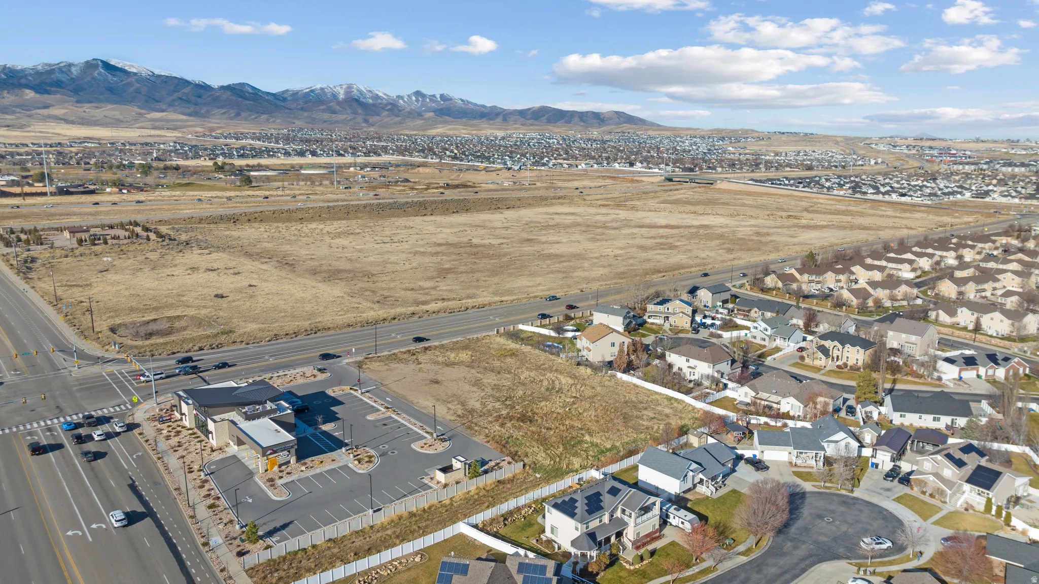 View of property location with a mountainous background and nearby suburban area