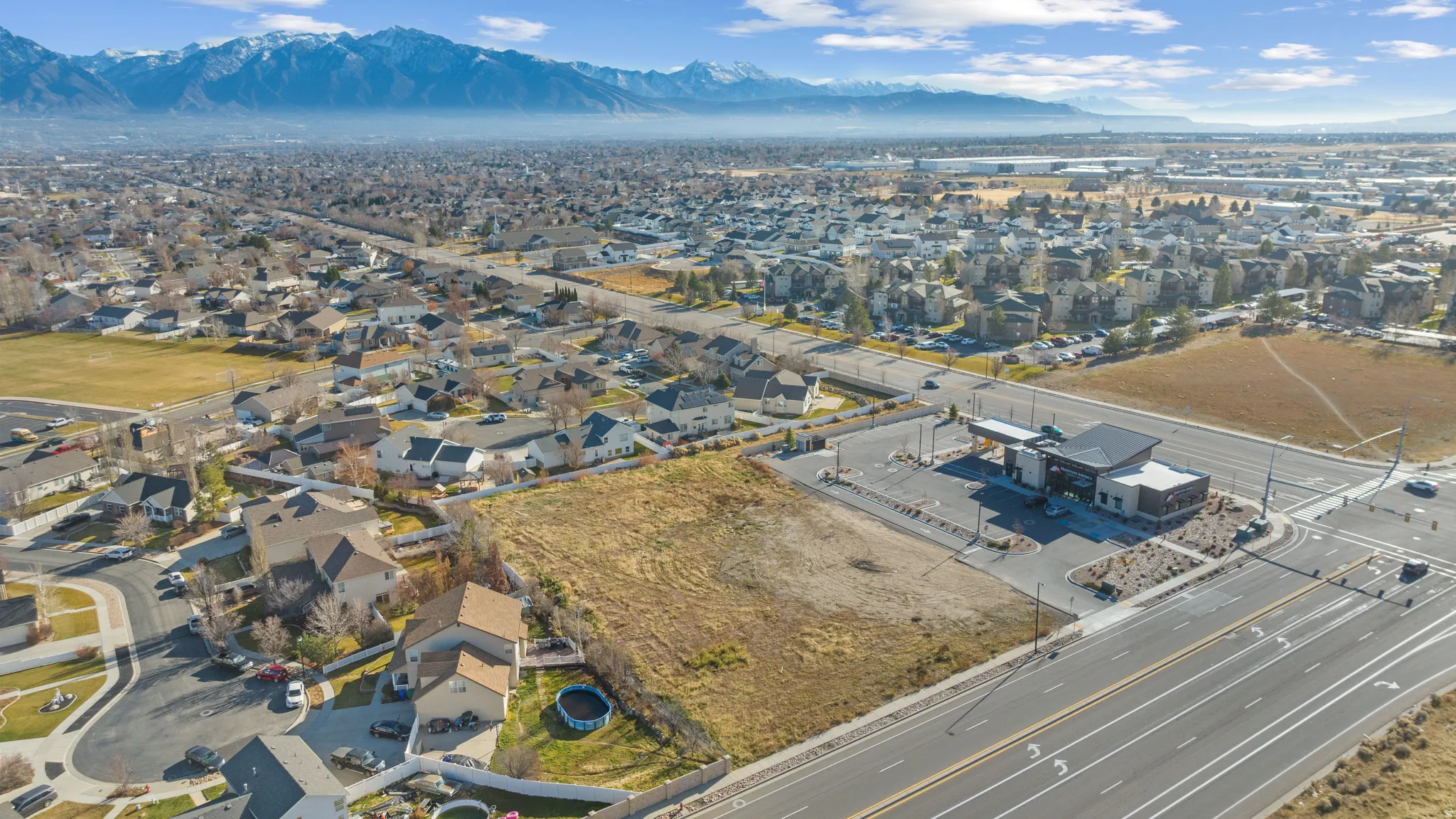 View of property location featuring nearby suburban area and a mountain backdrop