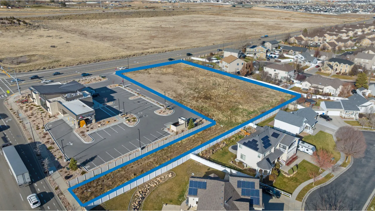 Aerial perspective of suburban area featuring property boundaries highlighted
