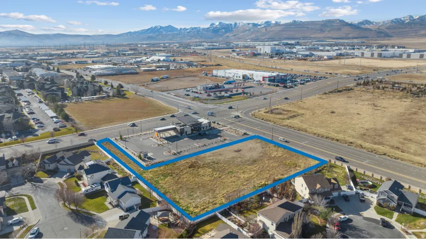 Aerial overview of property's location featuring property parcel outlined and a mountain backdrop
