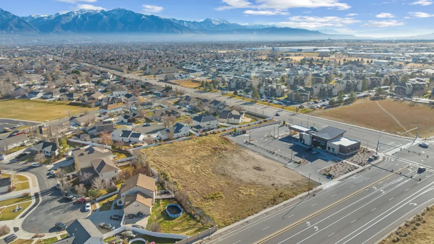 View of property location featuring nearby suburban area and a mountain backdrop