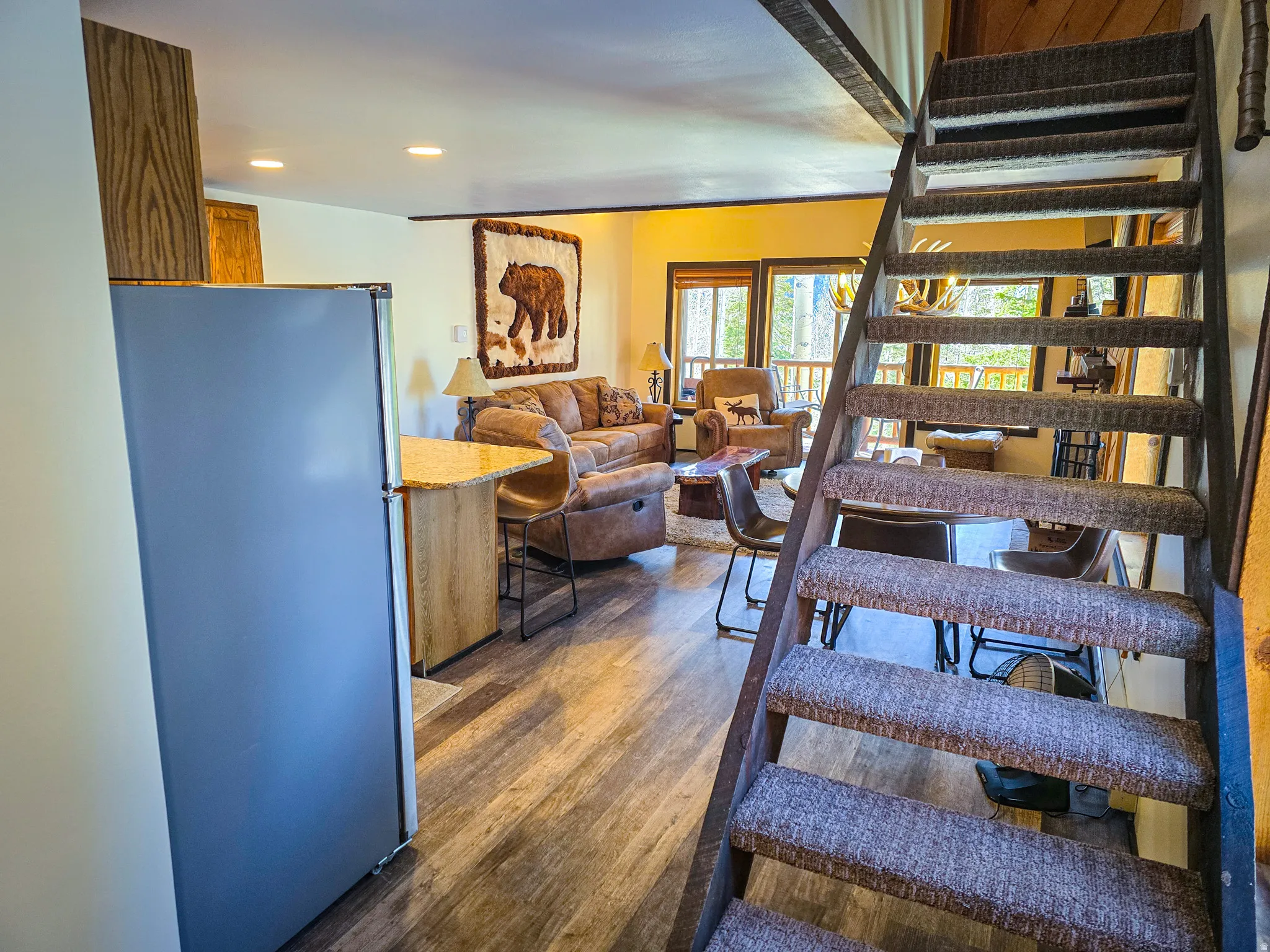 Staircase featuring wood finished floors and recessed lighting