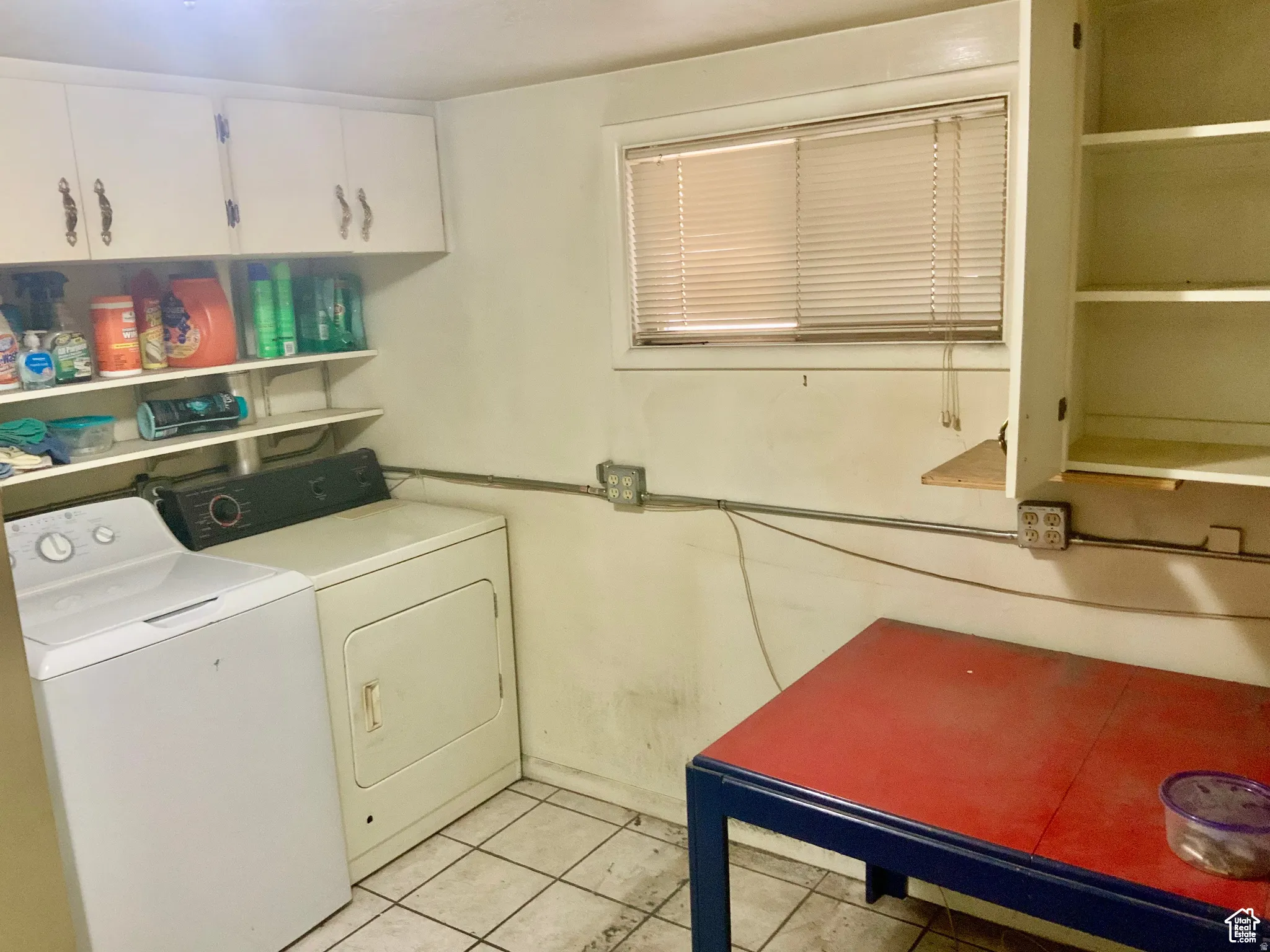 Laundry area featuring light tile patterned floors and washer and dryer