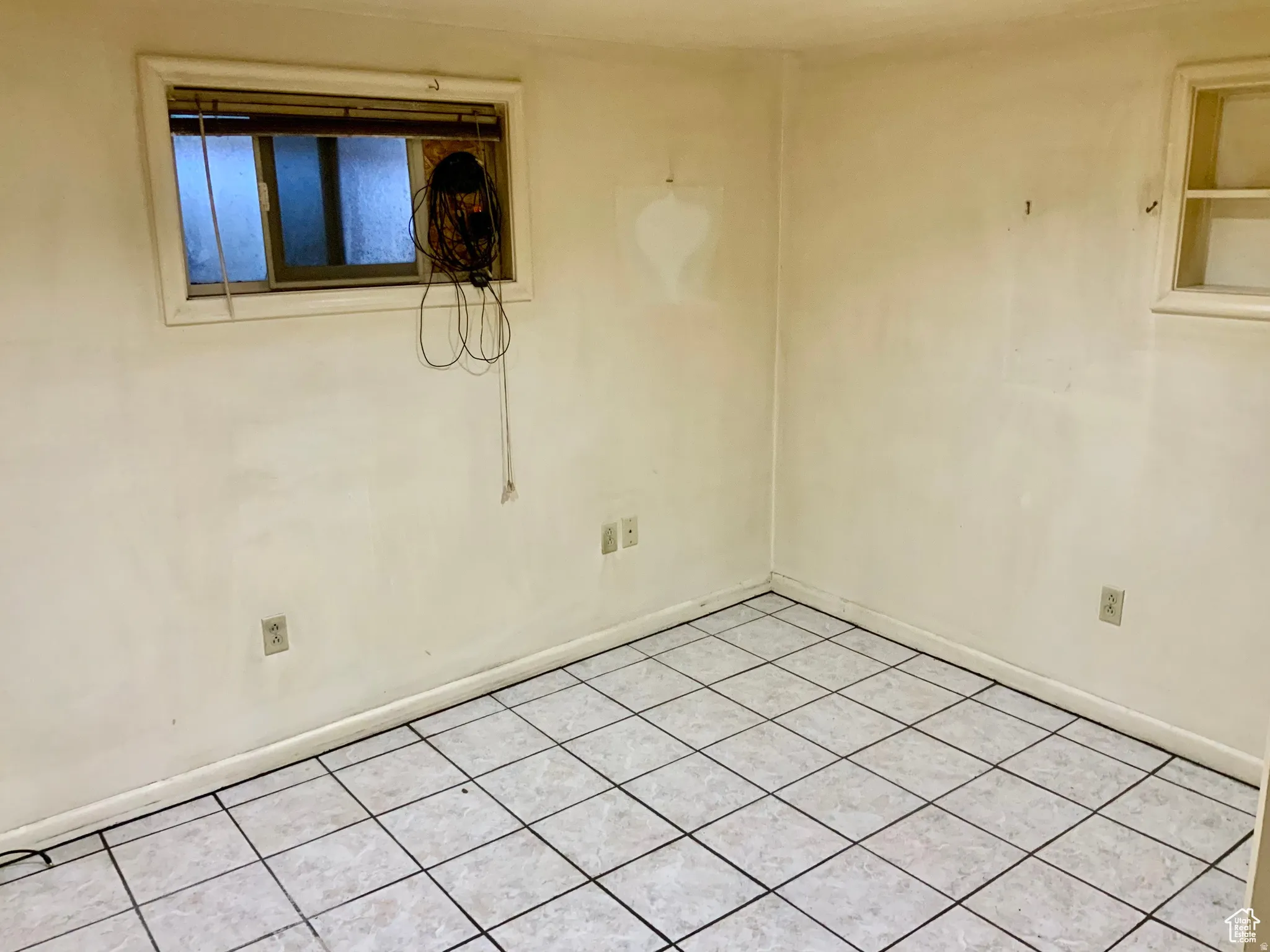 Spare room featuring baseboards