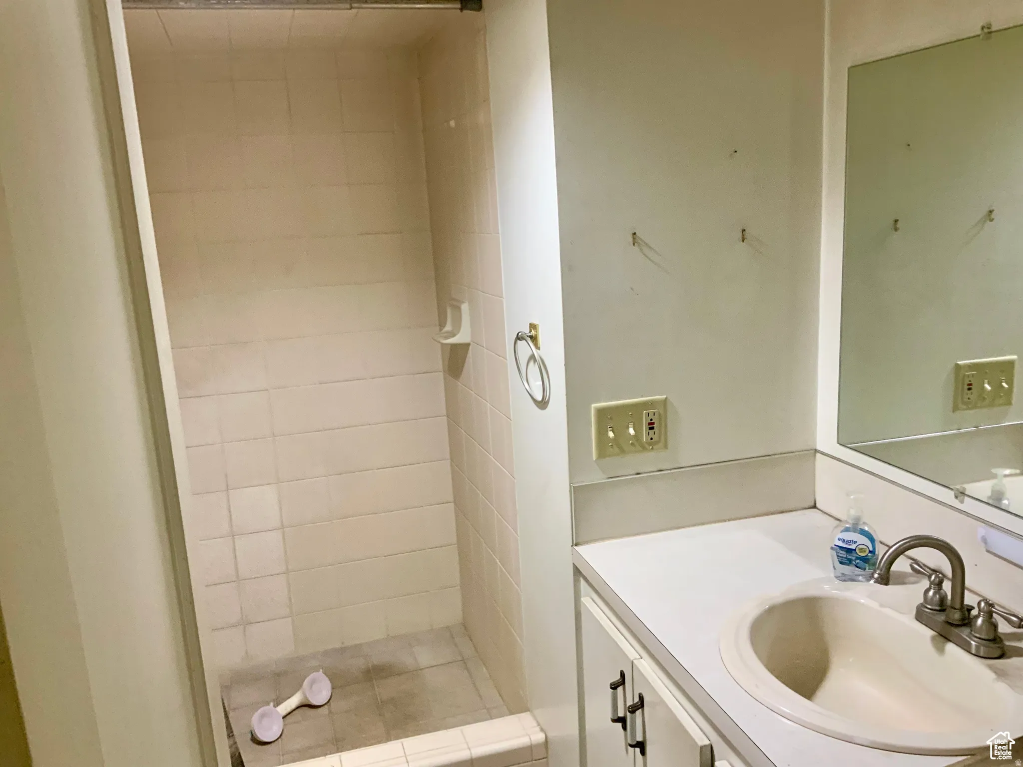 Bathroom featuring vanity and a shower stall