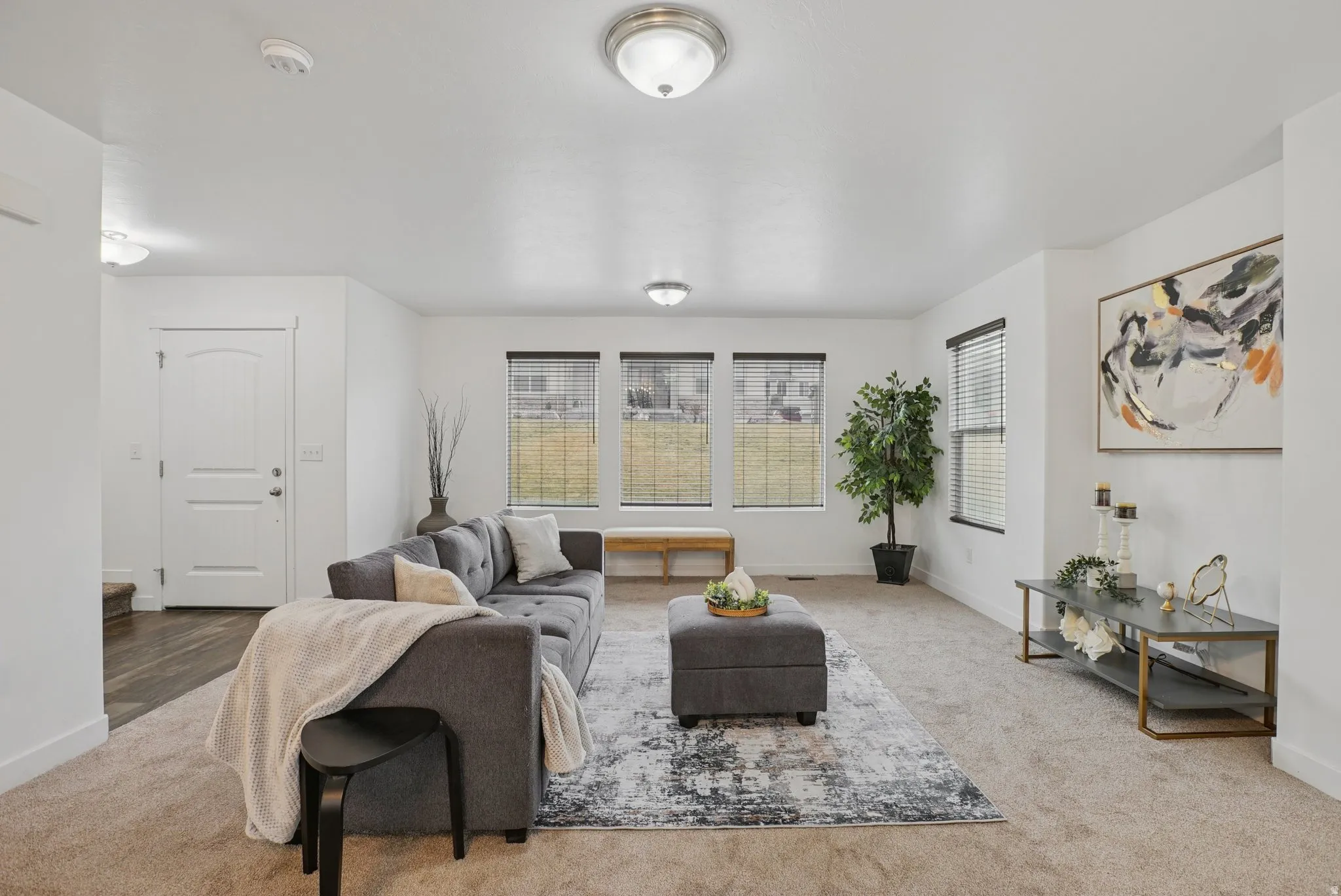 Carpeted living area with baseboards