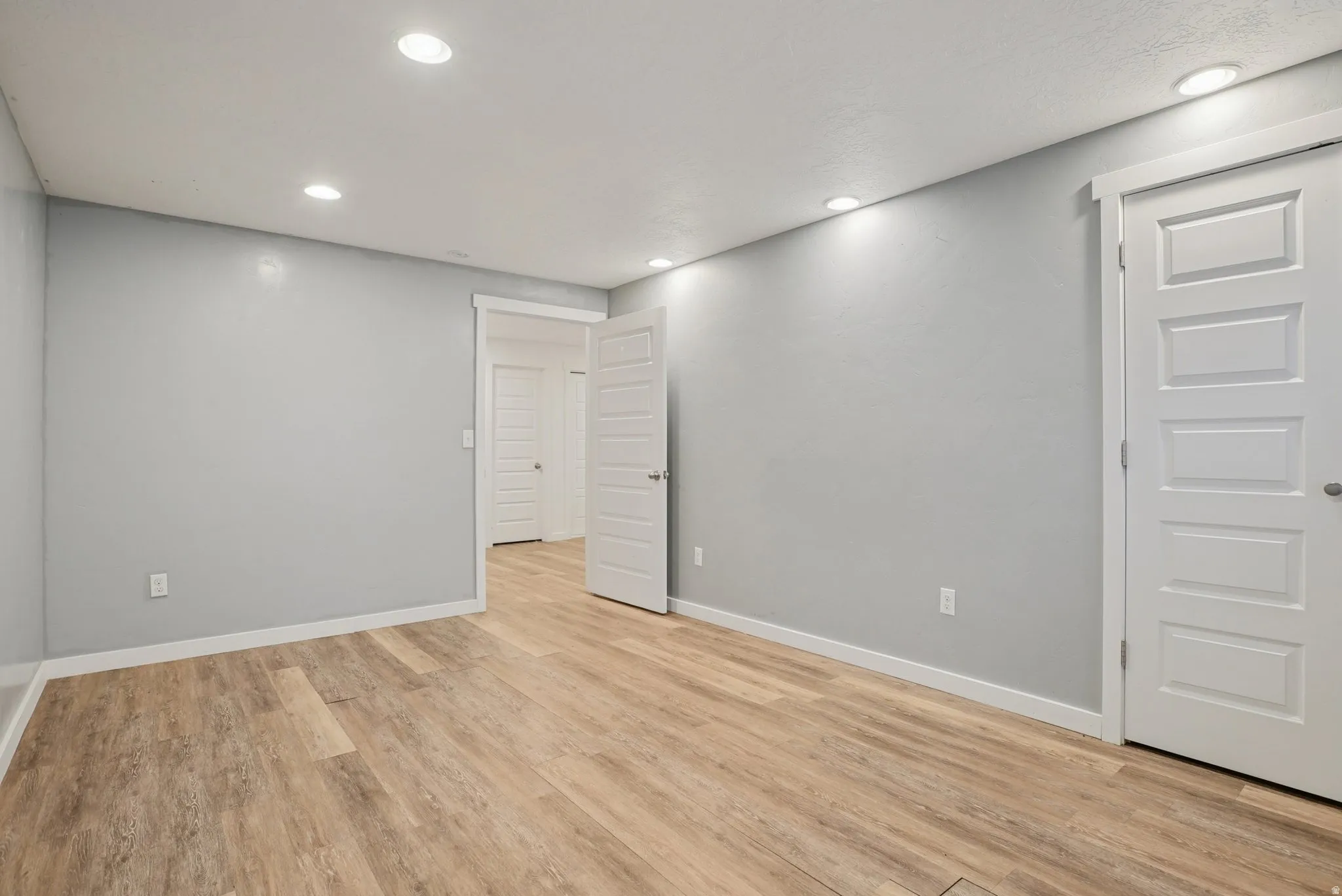 Spare room featuring light wood finished floors and recessed lighting