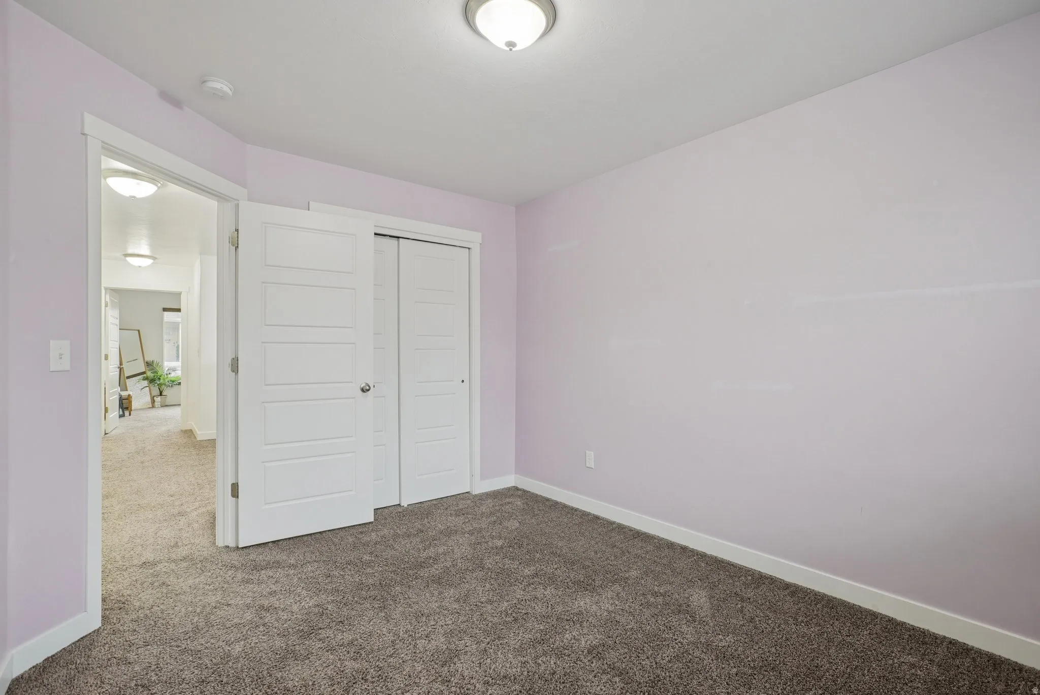 Unfurnished bedroom with carpet and a closet