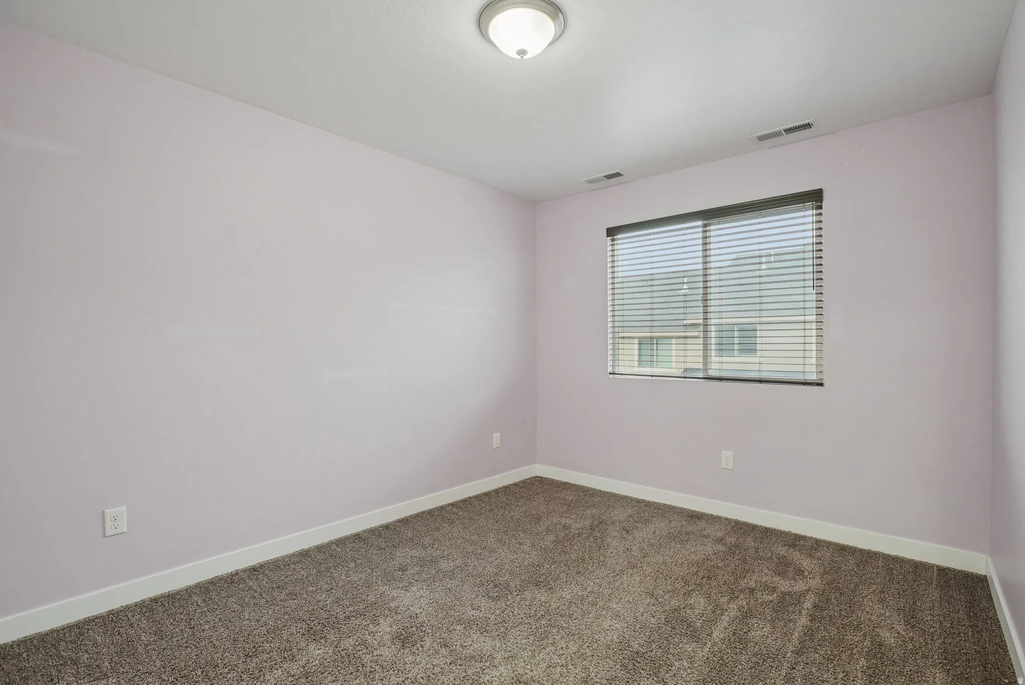 Unfurnished room featuring carpet and baseboards
