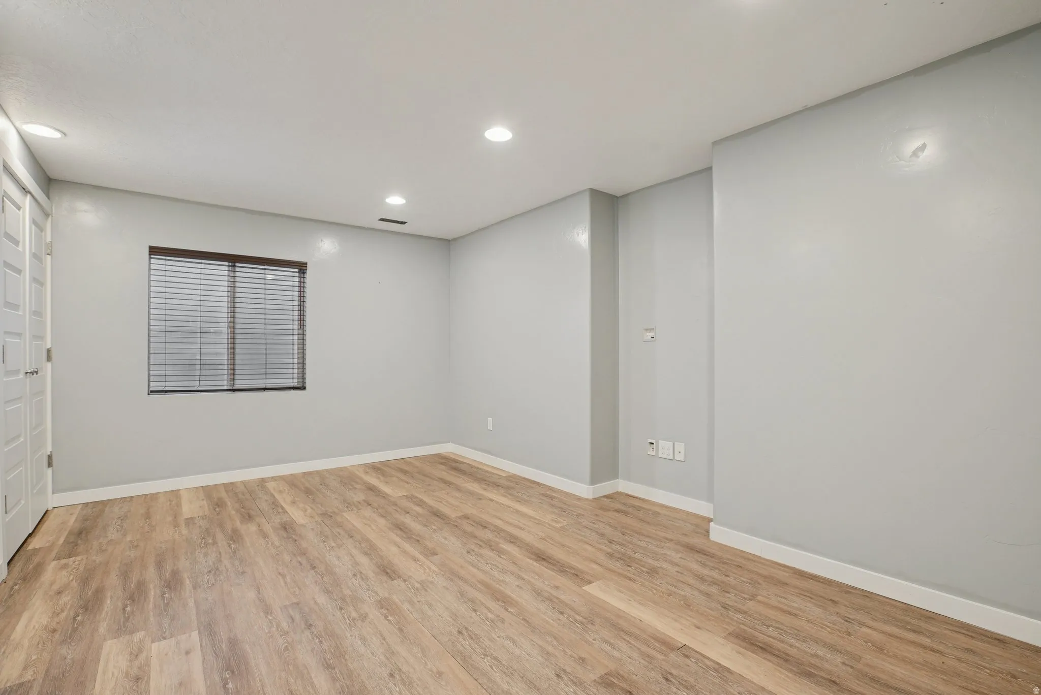 Unfurnished room with light wood finished floors and recessed lighting