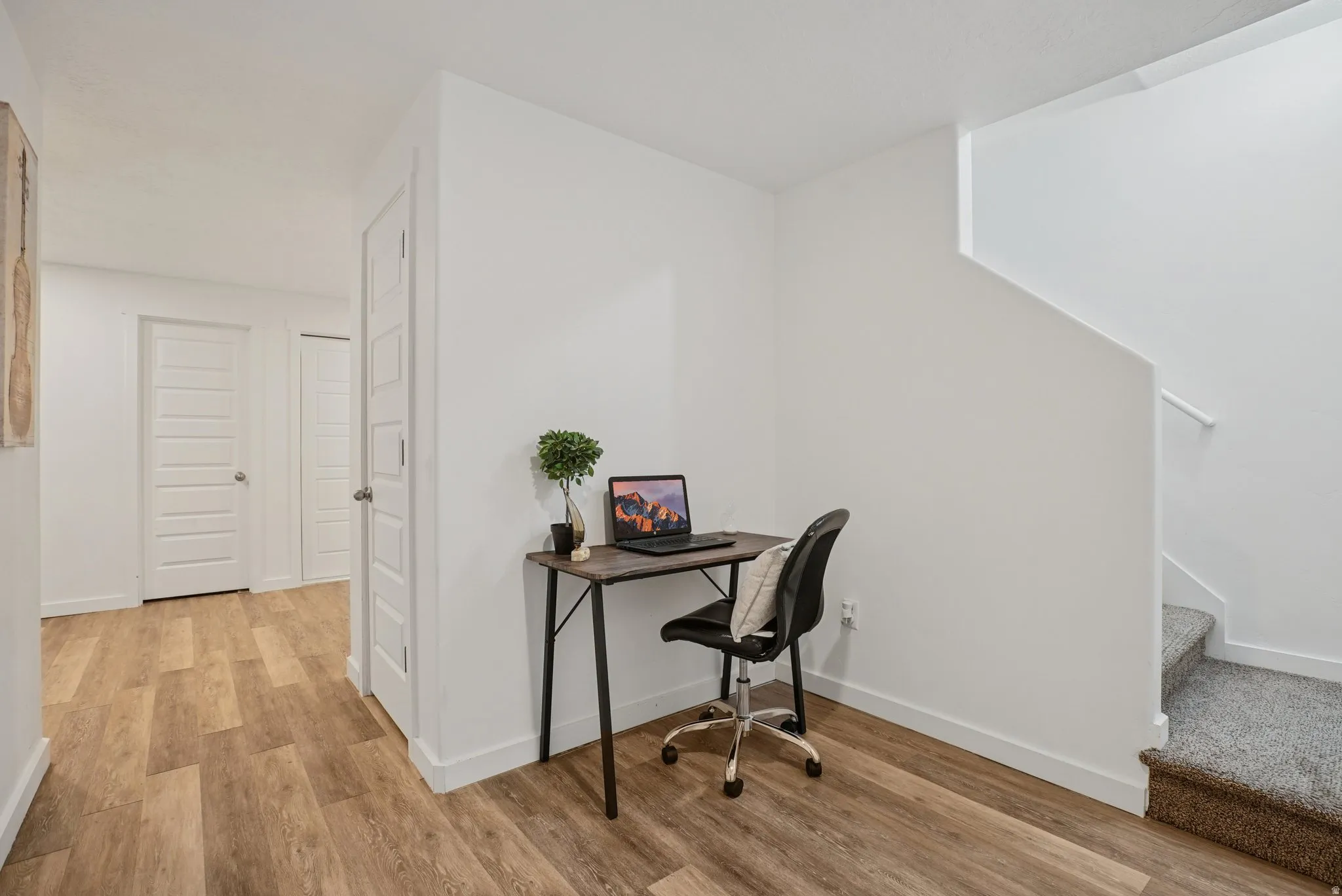 Home office featuring baseboards and light wood-style flooring