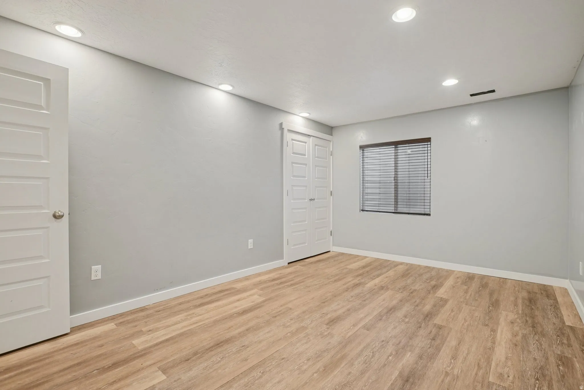 Spare room with light wood-style flooring and recessed lighting