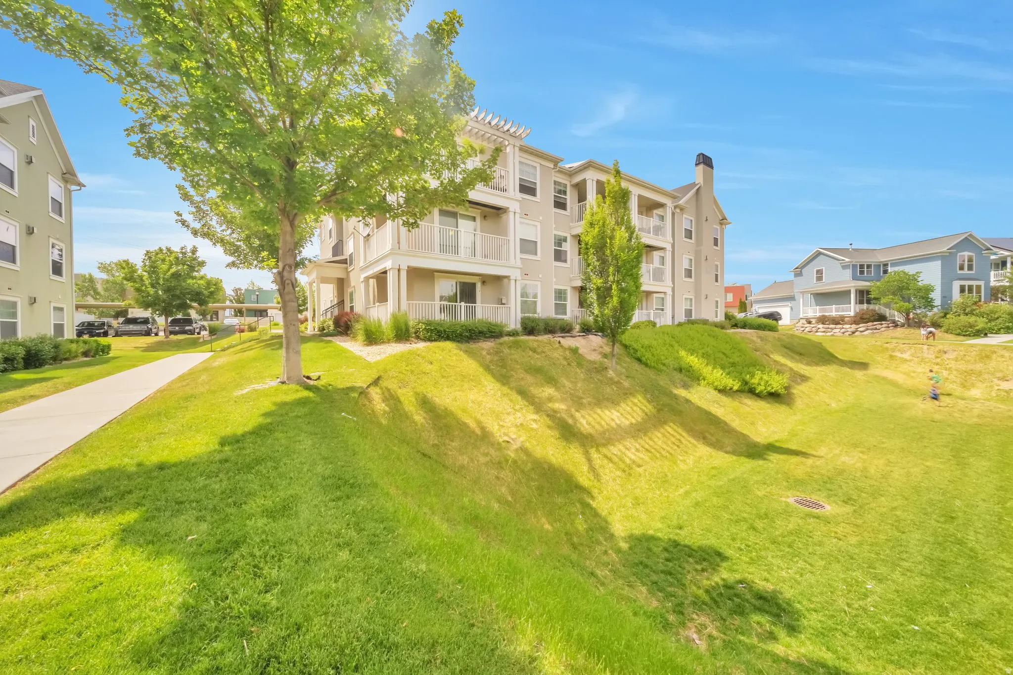 Surrounding community featuring a lawn and a balcony