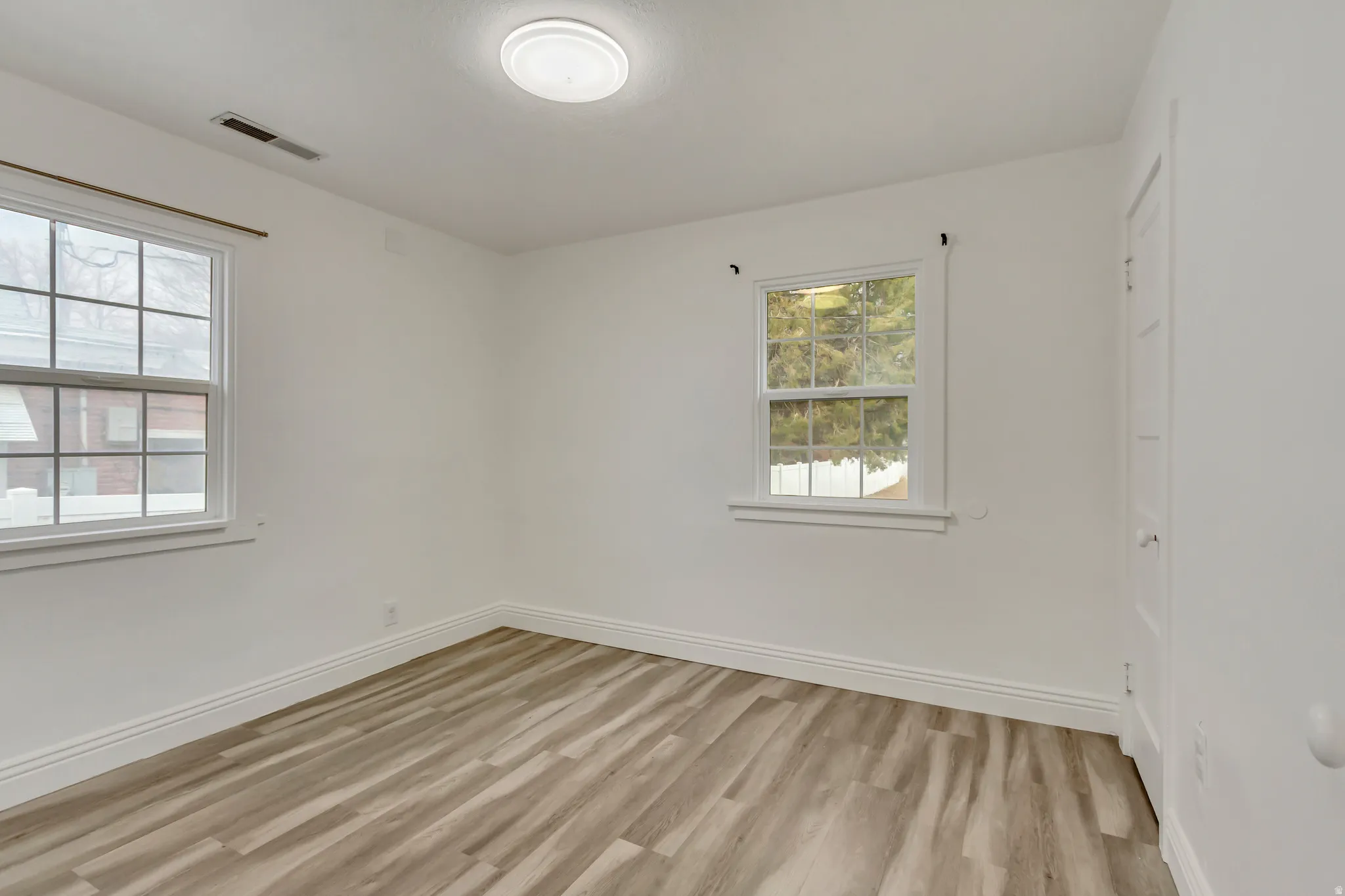 Empty room featuring light wood-style floors and baseboards