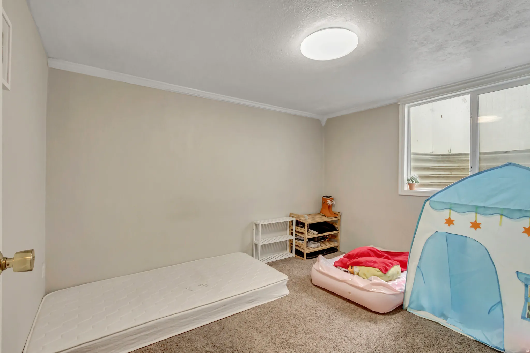 Bedroom with carpet floors and a textured ceiling