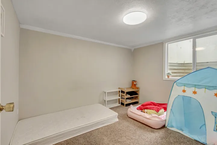Bedroom with carpet floors and a textured ceiling