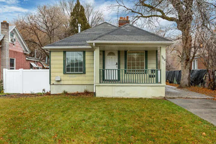 Bungalow featuring a porch and a chimney