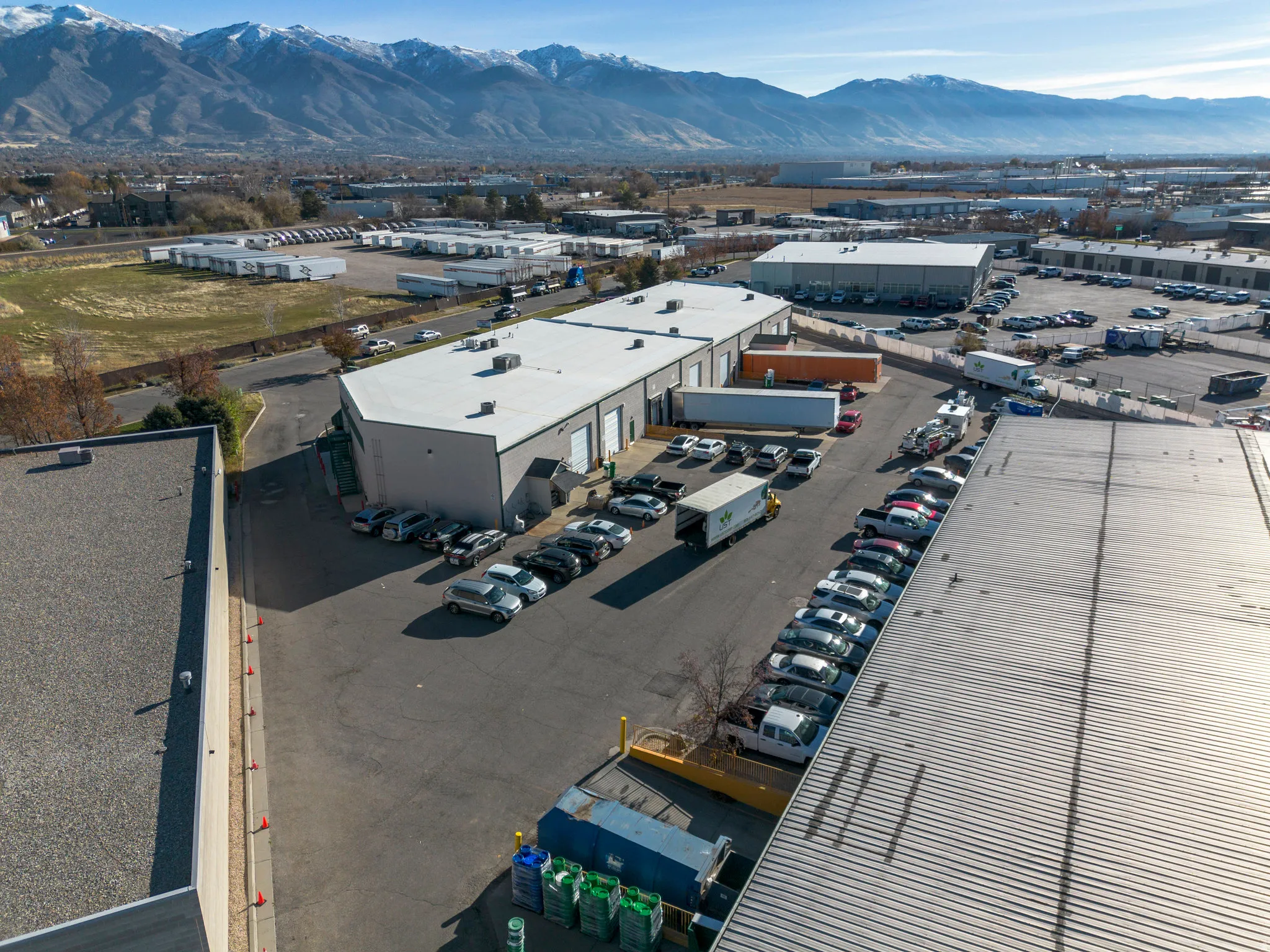 Bird's eye view of industrial structures and a mountain backdrop