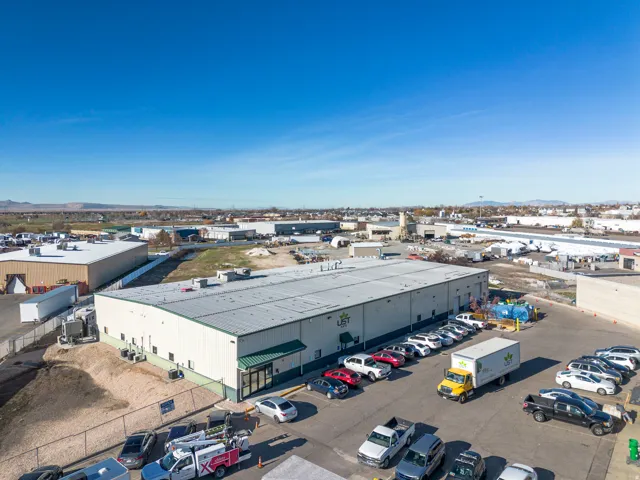 Bird's eye view of industrial structures and a mountain backdrop