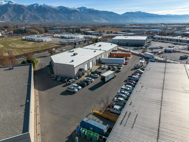 Bird's eye view of industrial structures and a mountain backdrop