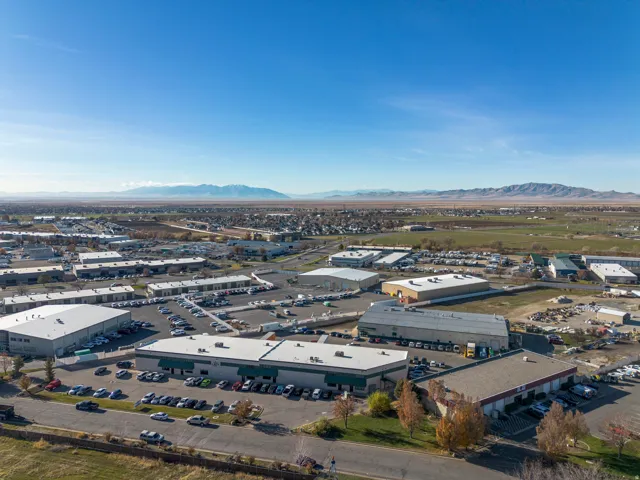 Aerial view of industrial structures and a mountain backdrop