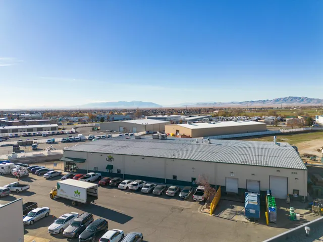 Drone / aerial view of a mountain backdrop and industrial structures